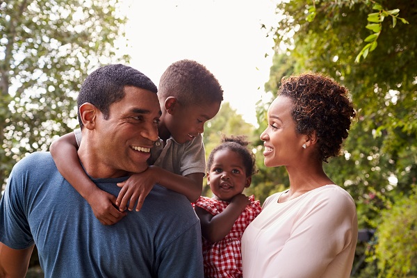 Mother and father walking in the park with their two children