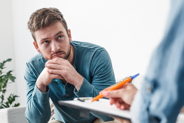 Man looking at a person who is out of view of the camera